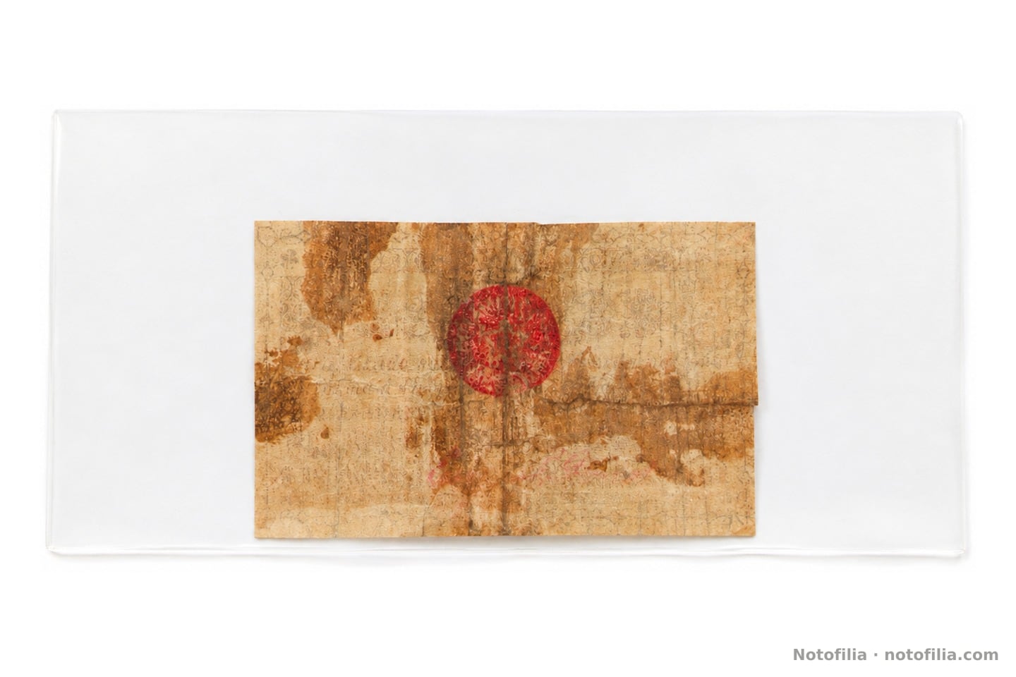 Back of the same piece: browned paper, a red circular seal, stains, folds, and faint manuscript; in a sleeve, unslabbed.