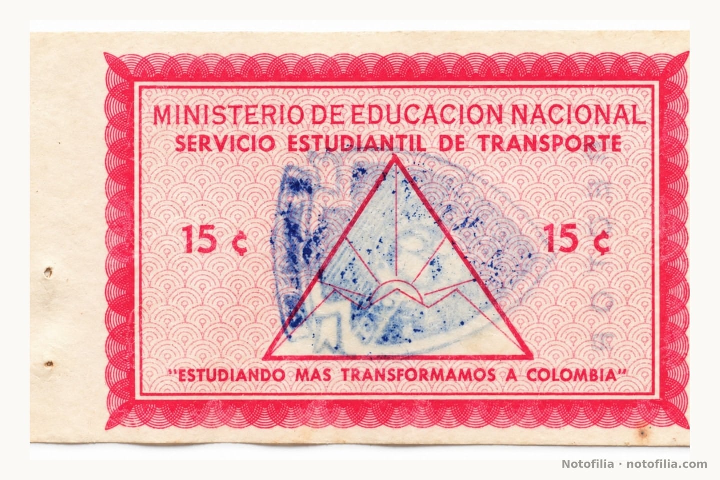 Face of the Ministry of National Education 15-centavos student-transport ticket, in red ink: a triangle with sun and mountains, the face value 15 ¢, the motto Estudiando más transformamos a Colombia, and a smeared blue stamp.