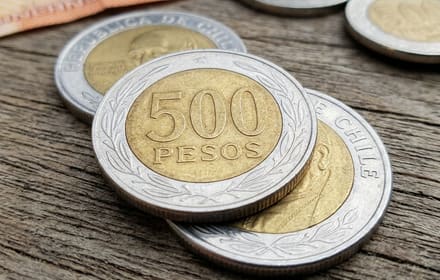 Chilean bimetallic 500-peso coins on wood: reverse with the value 500 and obverse with the cardinal’s portrait