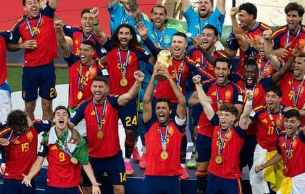 Spain’s football team celebrating with gold medals and lifting the FIFA World Cup