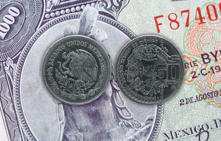 Two 1984 Mexican 50-peso coins with Coyolxauhqui on an old thousand-peso note